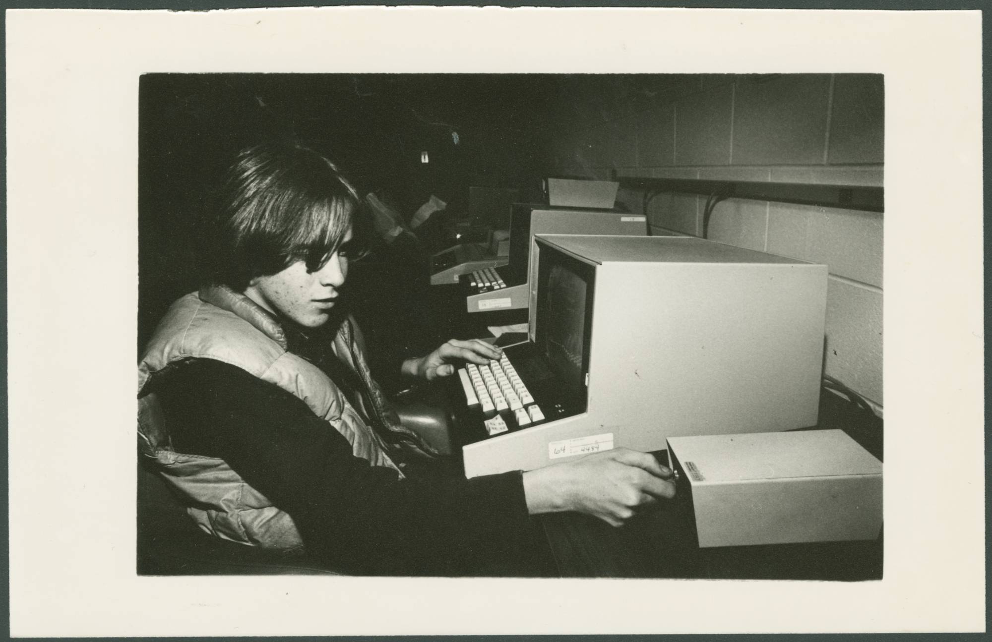 Computing student with attempting to work at computer in 1975.